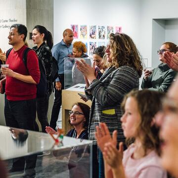 Group of visitors to Thacher Gallery clapping
