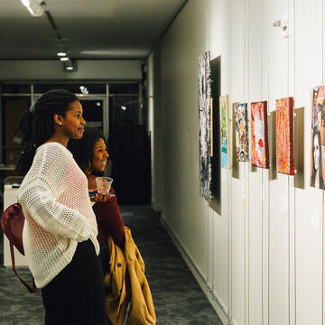 Two people admiring art at Thacher Gallery