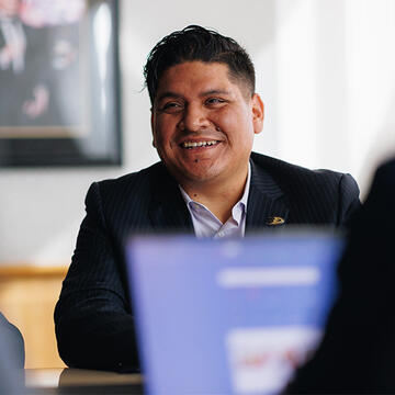 Sport management student in business attire smiling