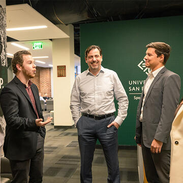 Professor Daniel Rascher chatting with students