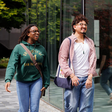 two students walk outside on usf campus