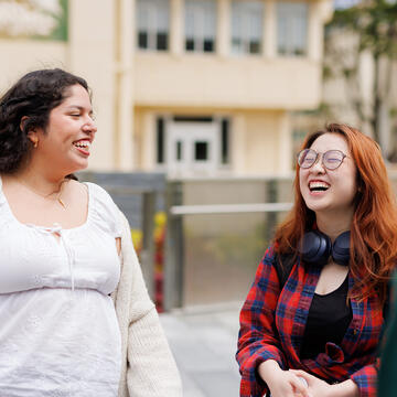 two students laughing together outside