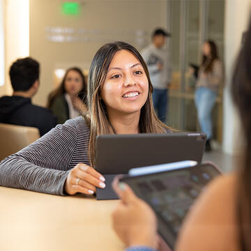 Student chatting with a peer at Orange County campus