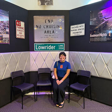 Brianna Fernandez MA ’26 at “Lowrider Lane Corner” during the CaLOWfornia Love exhibit at the California State Fair, hosted by the Sacramento Lowrider Commission.