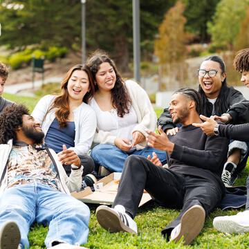 group of students hanging out on grass outside