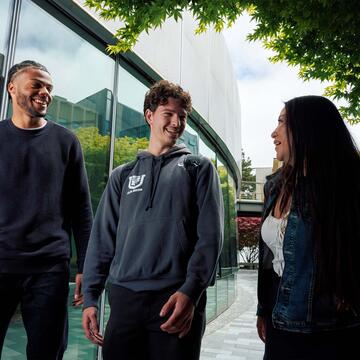 Three students walking on campus