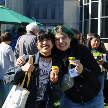 students hold up cupcakes during centennial bbq kickoff event