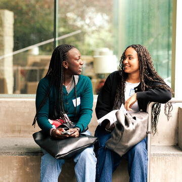 two students talking together outside