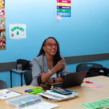 Michelle Hector meeting with a student in a classroom