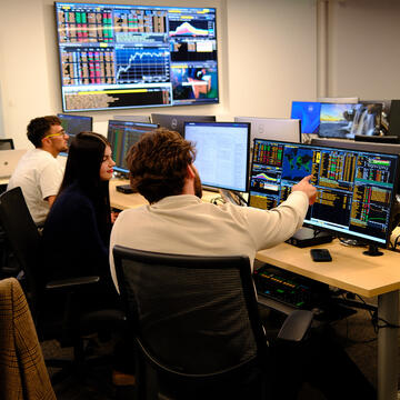 Students analyzing financial data on in a university classroom