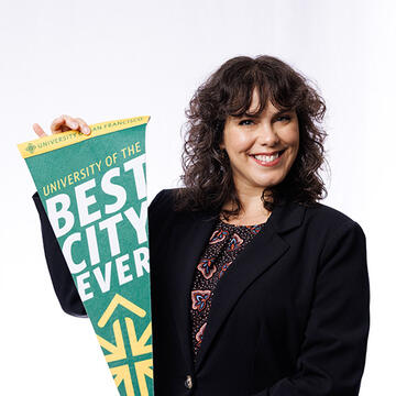 USF employee holding "USF Best City Ever" sign, smiling