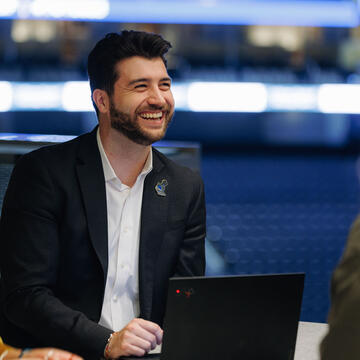 Student smiling at computer.