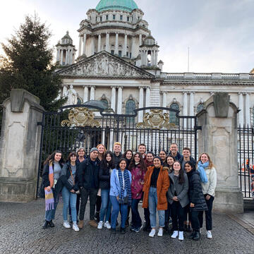 group of usf students posing in front of international landmark