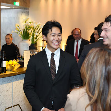 Student in suit at SOM Centennial Party