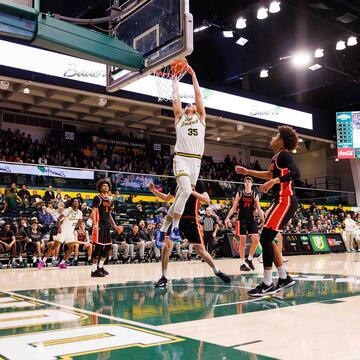Junior Forward Junjie Wang dunks during the Inaugural Bill Russell Impact Classic