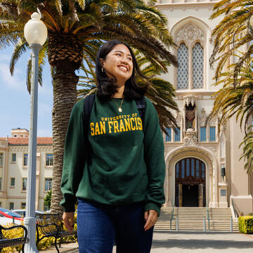 Student walks in front of Lone Mountain.