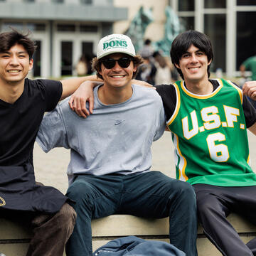 students sit together outside