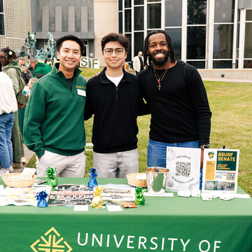 Students standing at ASUSF Senate booth during event outside