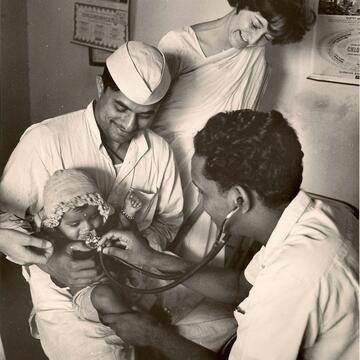 Mary Jo Clark and doctors caring for a baby