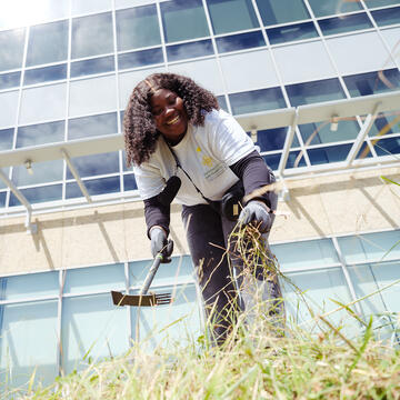 student uses gardening tools in Mission Bay San Francisco
