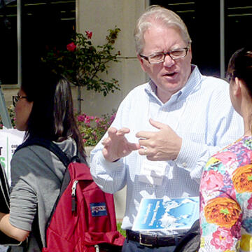 Collins speaking with a student