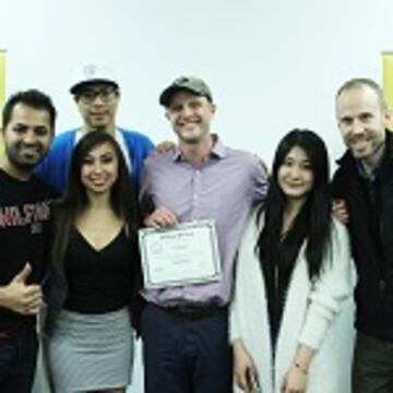 Team standing together with their certificate