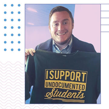 Flavio Bravo holding shirt that says "I support undocumented students"
