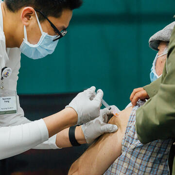 Norman Feng giving vaccination