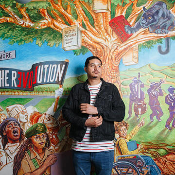 Nico Bremond in front of mural