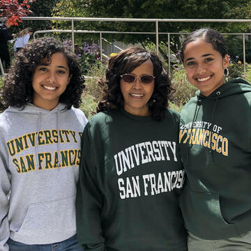 Mercy, left, and Merha Mehzun, with their mother in the center