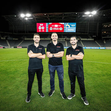 Students standing on a soccer field