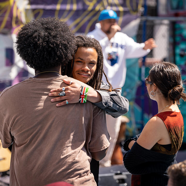 usf student hugging someone outside