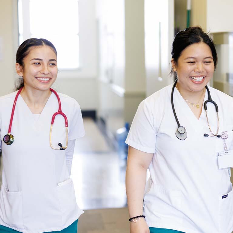 Two nursing students in scrubs