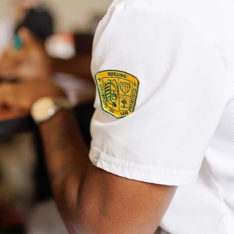 School of Nursing logo on a nursing student's scrub