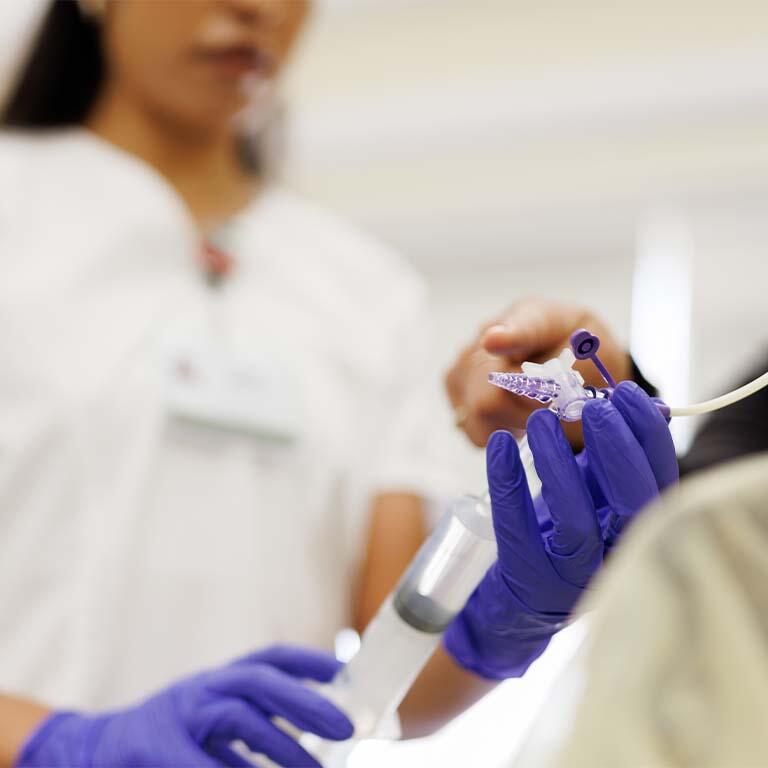 Student holding a syringe