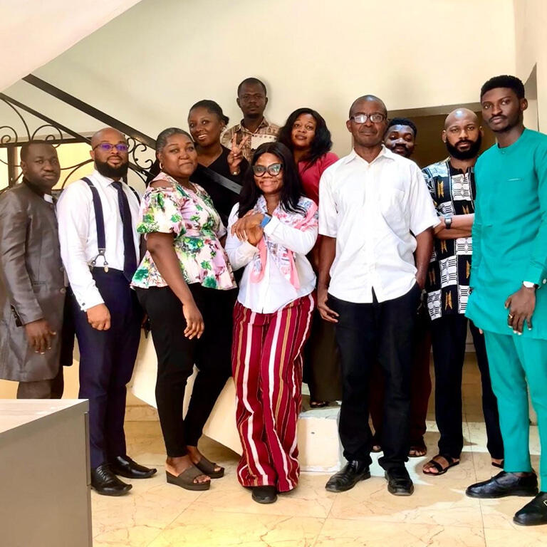 Airah standing with her team