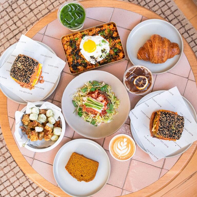 Birds eye view of a table with featuring an array of signature Korean-American dishes at Sōhn.