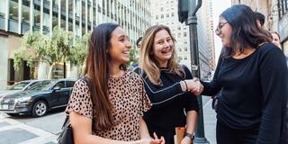 Students chat on a downtown street