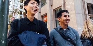 Students walk on a downtown street.