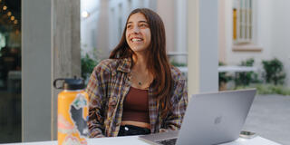 Student with a laptop studying.