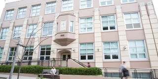 Students walk by one of the entrances to the School of Education building