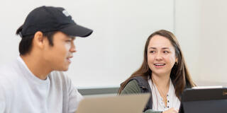 Two students chatting in class.