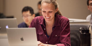 Student sitting with their laptop.