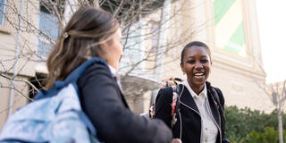 students walking together outside on campus