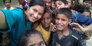 Tina Jain MSMI ’23 with students in the Varanasi government school