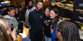 Steph Curry poses for photo with young people
