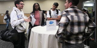 students talk with Salesforce rep