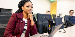 student sitting at table in class