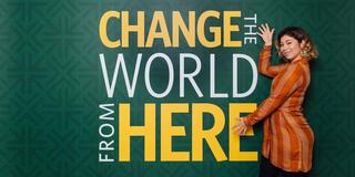 Karen Soto presenting a change the world from here sign