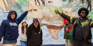 students point at mural